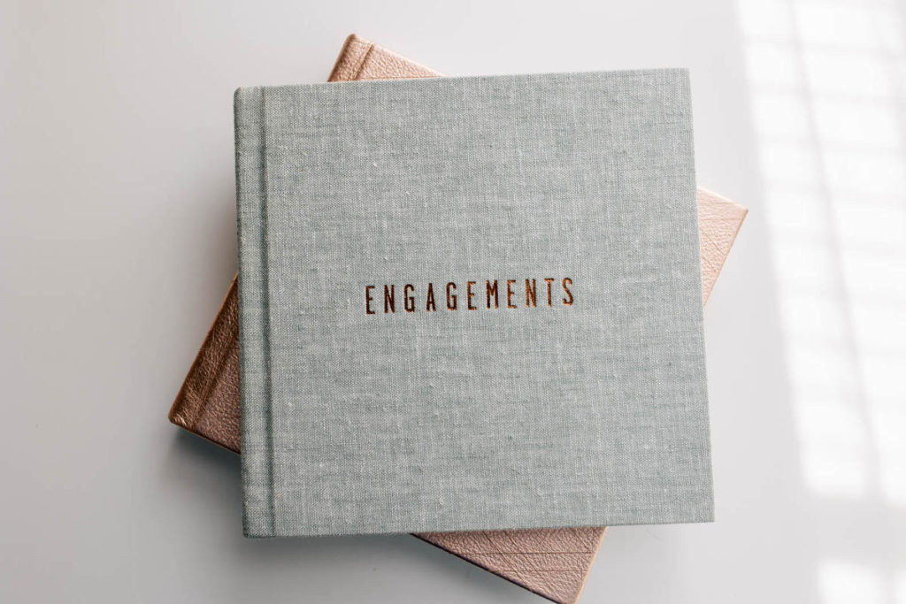 grey book with engagements stacked on top of another book