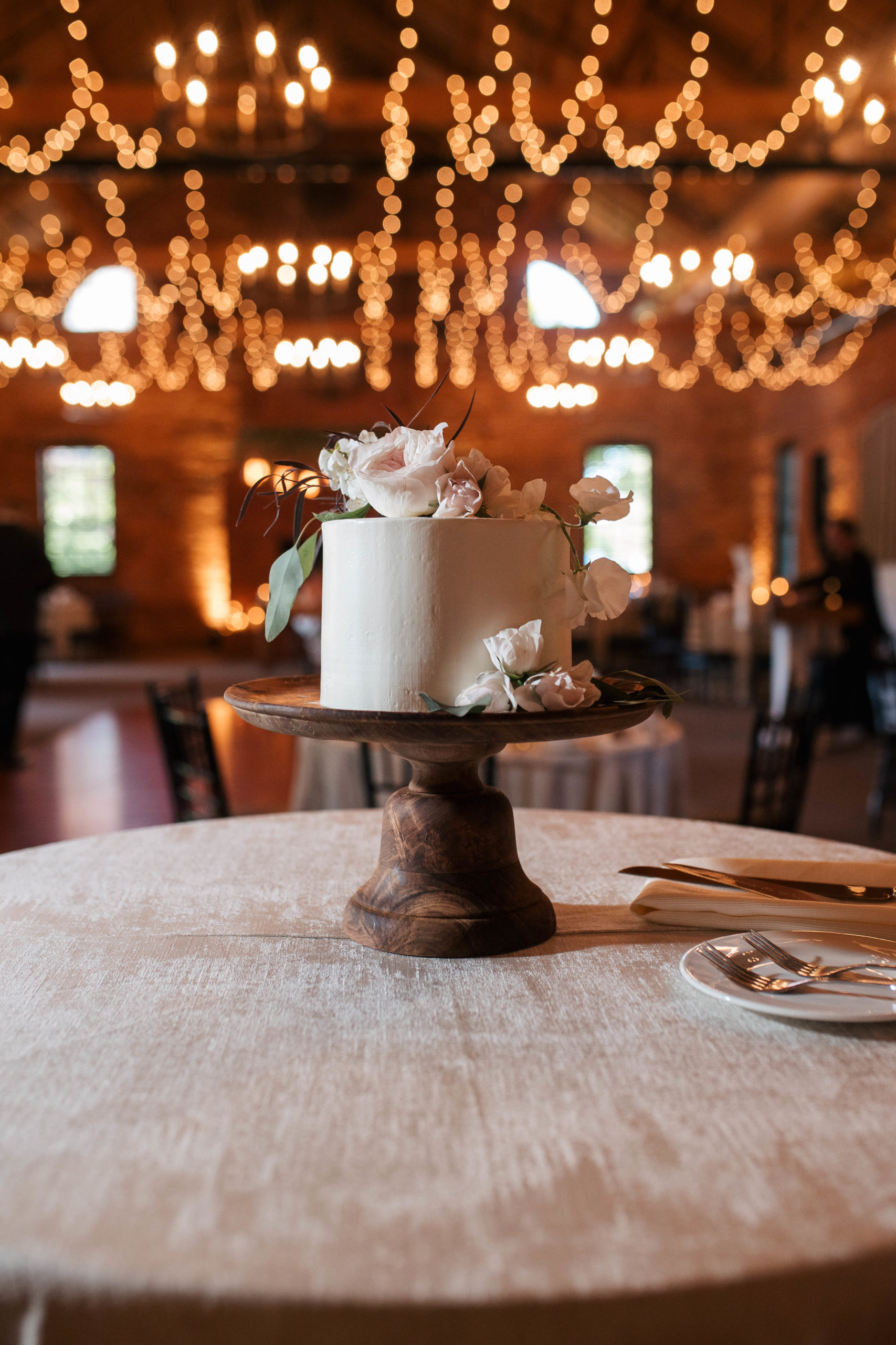 white wedding cake sitting on a table