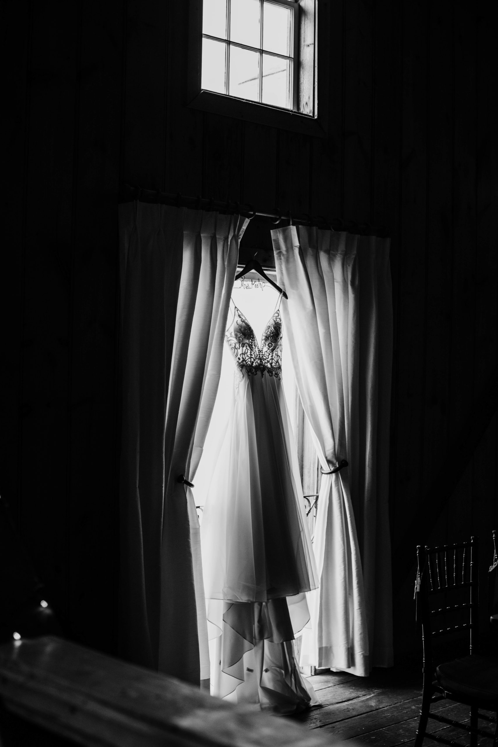 wedding dress handing in a tall window